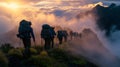 group hikers walking up the side of a mountain towards a foggy sky Royalty Free Stock Photo