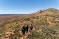 a group of Hikers on the way to the top of Mount Sonder just outside Alice Springs, West MacDonnel National Park, Australia Royalty Free Stock Photo