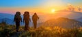 Group hiking in mountains at sunset, exploring nature on summer journey, active hikers together Royalty Free Stock Photo