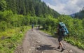 Group of hiking tourists going to Carpatian mountains