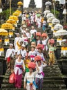 Besakih, Bali / Indonesia - April 09 2015 : A group of Hindu Balinese people decend the stairs of Besakih temple in Bali