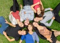 Group of hispanic friends laying down in park