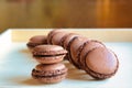 Group of homemade chocolate macarons on a tray