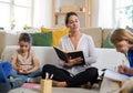 Group of homeschooling children with teacher studying indoors, coronavirus concept. Royalty Free Stock Photo