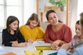 Group of homeschooling children with teacher studying indoors, coronavirus concept. Royalty Free Stock Photo