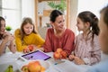 Group of homeschooling children with teacher studying indoors, coronavirus concept. Royalty Free Stock Photo