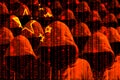 Group of hooded hackers shining through a digital chinese flag