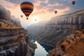 A group of hot air balloons flying over a canyon at sunset