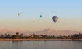 A group of hot air balloons soar in the air near Luxor. Royalty Free Stock Photo