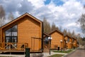 A group of houses in the same style. Trendy modern barnhouse style houses. bright blue sky