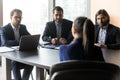 Group of hr managers holding job interview with female candidate.