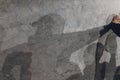 Group of human shadows on the stone wall at sunset time. Royalty Free Stock Photo