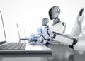 Group of humanoid robots with laptop computers isolated on white