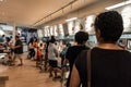 Hungry customers queue at IKEA cafeteria to select food.