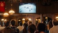 Group of Ice Hockey Fans Watching a Live Match Broadcast in a Sports Pub on TV. People Cheering Royalty Free Stock Photo