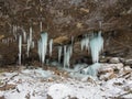 Group icicles hang down from a shelf in a cave Royalty Free Stock Photo