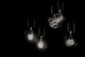 Group of incandescent light bulbs on black background with copy space. Generative AI Royalty Free Stock Photo