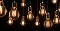 Group of incandescent light bulbs on black background Royalty Free Stock Photo