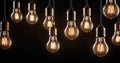 Group of incandescent light bulbs on black background Royalty Free Stock Photo