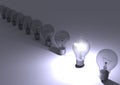 Group of incandescent light bulbs with one bulb illuminated. Royalty Free Stock Photo