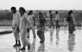 Agra, India - August 19, 2009: a group of Indians in the rain behind the Taj Mahal in Agra in India