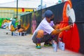 Group of individuals painting a mural on the side of a street-facing brick wall in Tegucigalpa