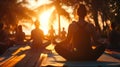 Group of individuals practicing yoga on the beach at sunset, silhouetted against the serene ocean. Royalty Free Stock Photo