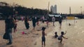 A group of tourists playing on the edge of the Ancol beach which is quite crowded Royalty Free Stock Photo