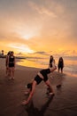a group of Indonesian women doing ballet movement exercises together very flexibly on the beach