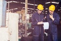 Group of industrial factory maintenance engineers inspect relay protection system using walkie talkie