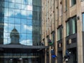 Group of industrial mountaineering workers hang over modern business building while washing exterior facade