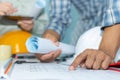 Group interior designer and architect planning and working on blueprint with safety helmet in meeting room Royalty Free Stock Photo