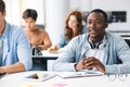 Group of international people listening to teacher at classroom