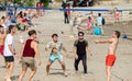 A group of international students from all over the world playing sand volleyball on the beach of bacvice in split. Man catching a