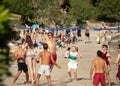 A group of international students from all over the world playing sand volleyball on the beach of bacvice in split. Man in mid air