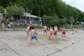 A group of international students from all over the world playing sand volleyball on the beach of bacvice in split. Wide shot of