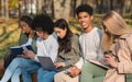 Group of international students studying at autumn park Royalty Free Stock Photo