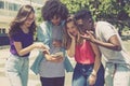 Group of international young adults gaming with phone Royalty Free Stock Photo