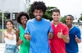 Group of international young adults showing thumbs in city Royalty Free Stock Photo