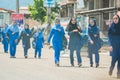 Unknown city, Iran, May 13, 2017. Students of iranian school walking on the street in hijabs