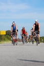 Group of Ironman triathletes cycling