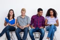 Group of jobless international young adults in a waiting room for job interview