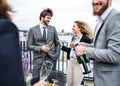 A group of joyful businesspeople having a party outdoors on roof terrace in city.