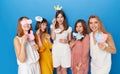 Front image of a group of joyful women to have gender reveals envent, isolated blue background.