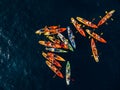 A group of kayakers gathered their kayaks in a heap in sea. Group swim in pairs kayaks. Concept banner travel. Aerial Royalty Free Stock Photo