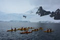 Group of kayakers by a glacier, Antarctic Peninsula