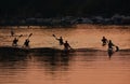 Group of kayakers in the kayaks on the river going to kayaking at sunset