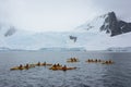 Group of kayakers by a glacier, Antarctic Peninsula