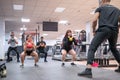 Group kettlebell workout in gym with individual coaching and diverse participants. Royalty Free Stock Photo