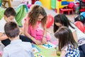 Group of kids applying colorful plasticine during educational activity